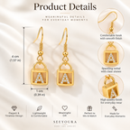 Product details graphic for SEEYOURA drop earrings, showing a pair of gold-toned square pendant earrings with clear stones forming the letter A, alongside close-up callouts and dimension measurements on a soft white satin background.