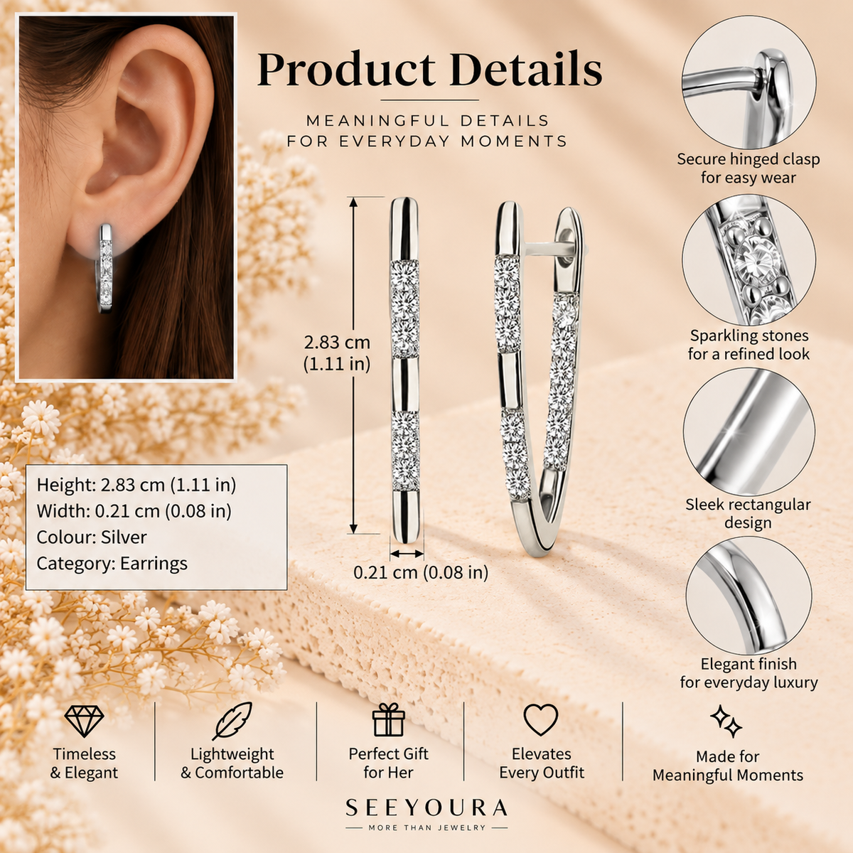 Silver huggie hoop earrings adorned with sparkling clear cubic zirconia stones, shown in a product details infographic with dimensions, a model wearing one earring, and feature callouts on a beige floral background.