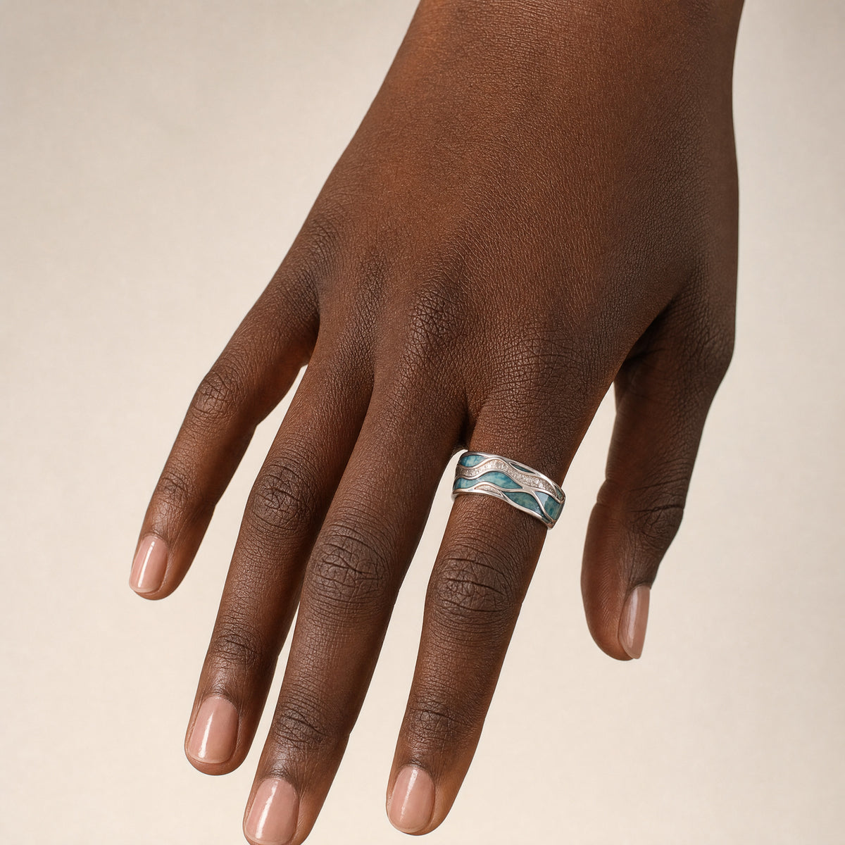 Beach Wave Ring — Silver worn on a hand with a deep skin tone