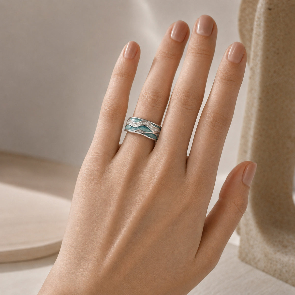 Beach Wave Ring — Silver worn on a hand with a light skin tone