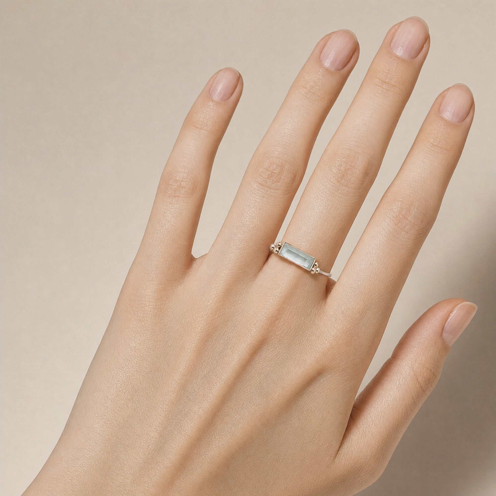 Blue Baguette Zirconia Ring for Women worn on a hand with a light skin tone