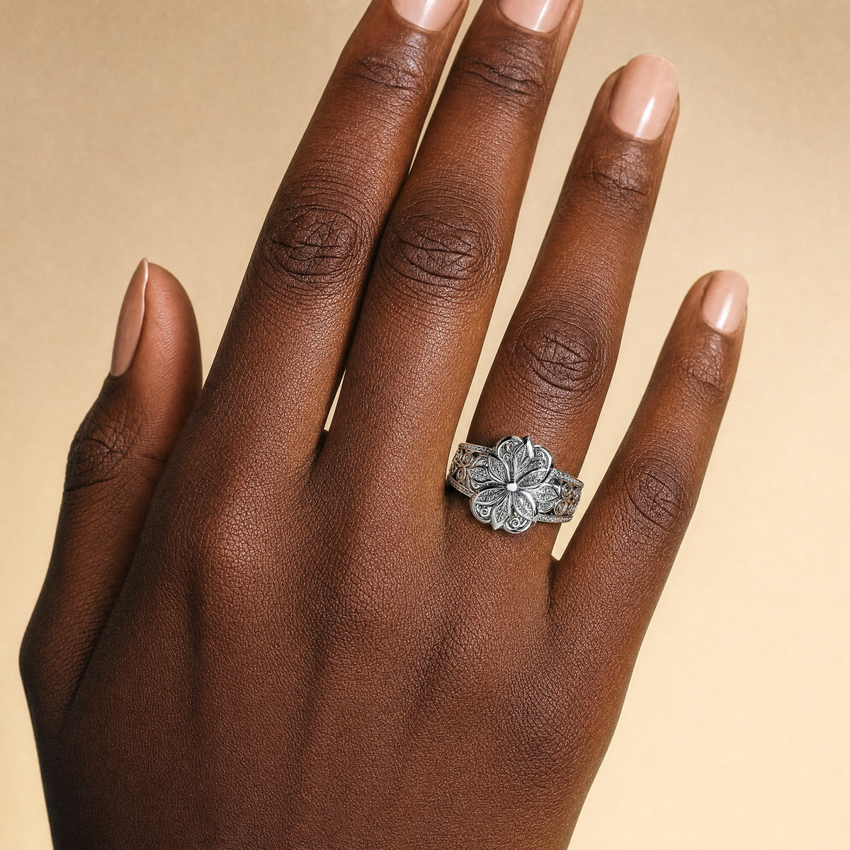 Flower Zirconia Ring — Silver worn on a hand with a deep skin tone