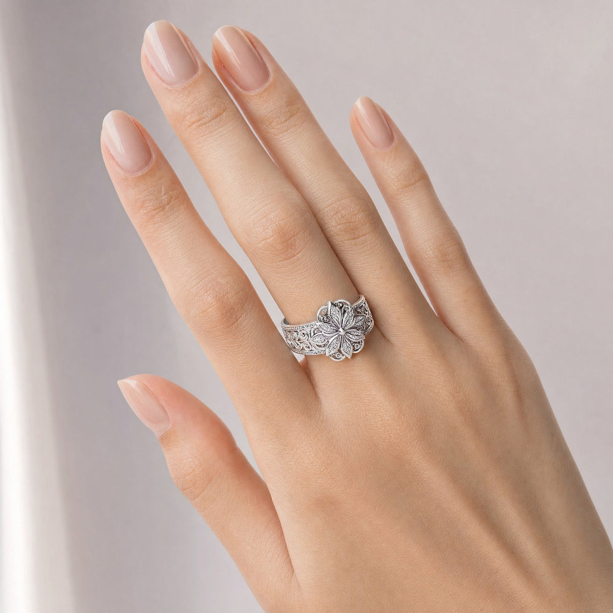 Flower Zirconia Ring — Silver worn on a hand with a light skin tone
