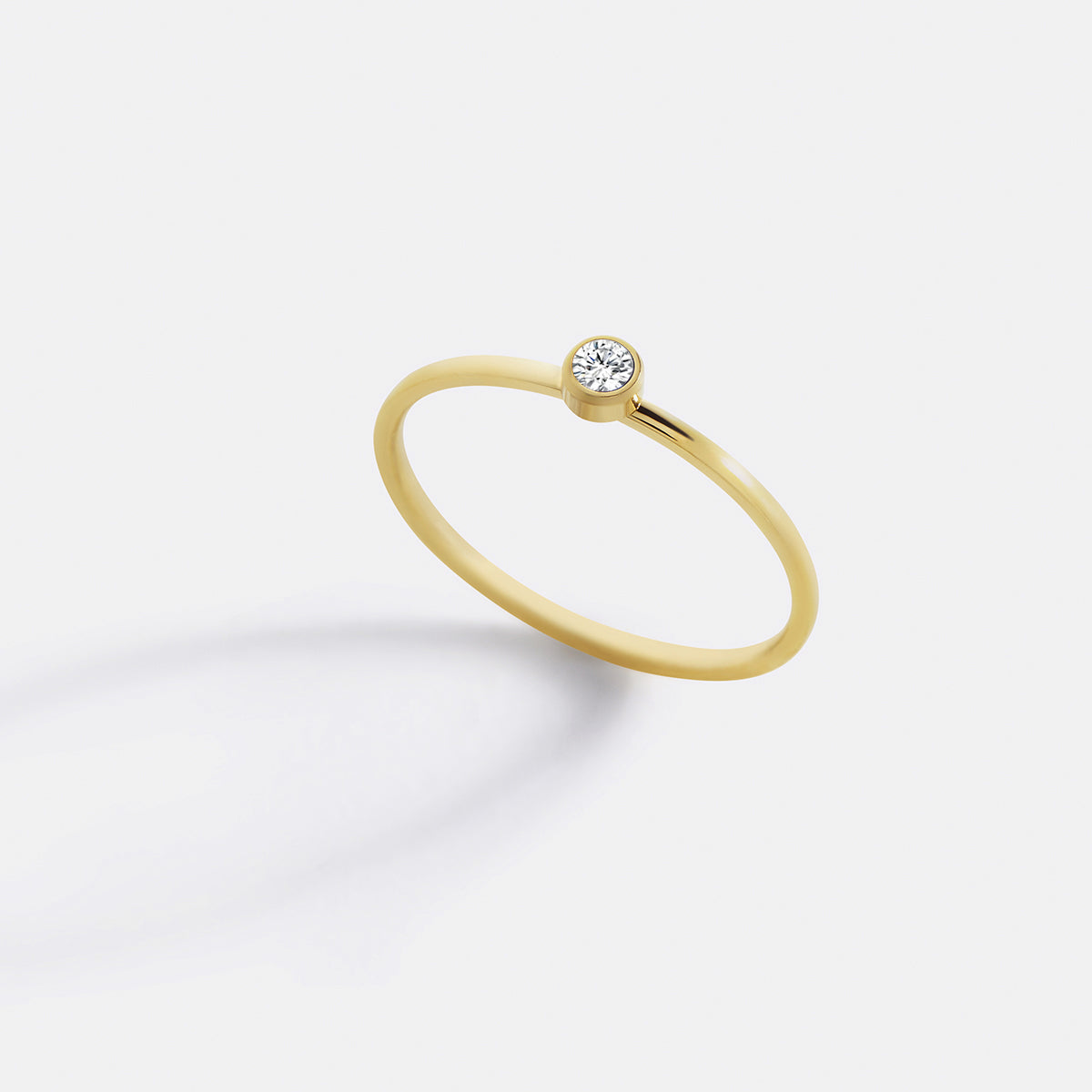 Minimalist Bezel-Set April Birthstone Stacking Band in gold by Seeyoura