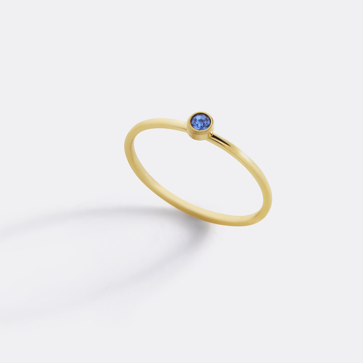Minimalist Bezel-Set December Birthstone Stacking Band in gold by Seeyoura